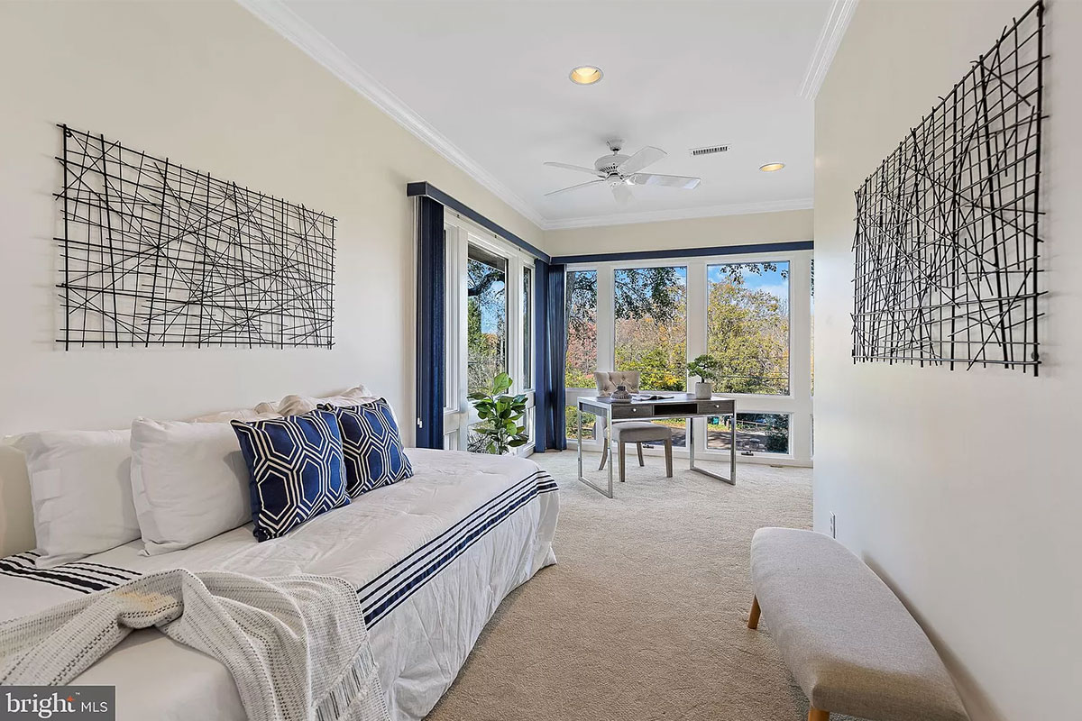 L-shaped bedroom with desk in one corner