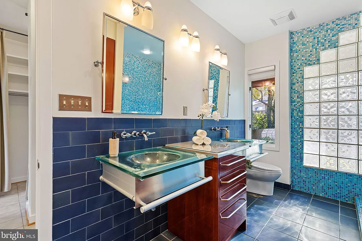 Blue tiled bathroom with floating double sinks