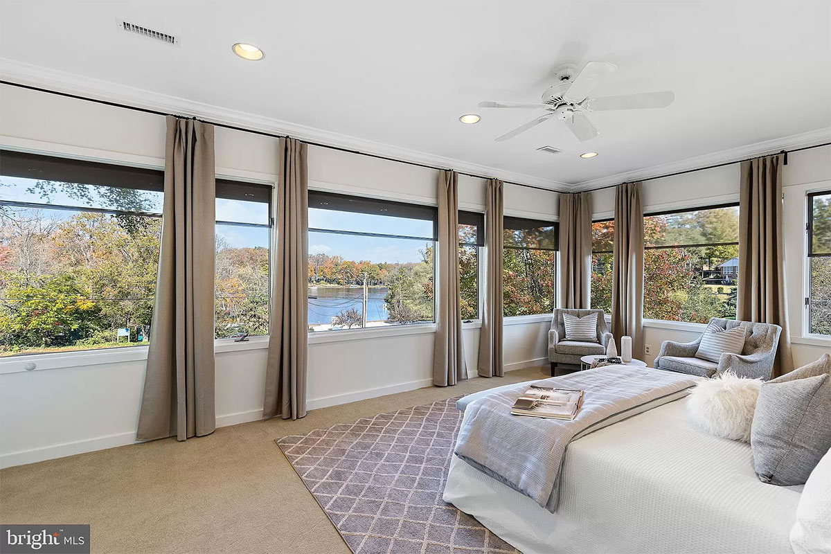 Bedroom with wall covered in windows