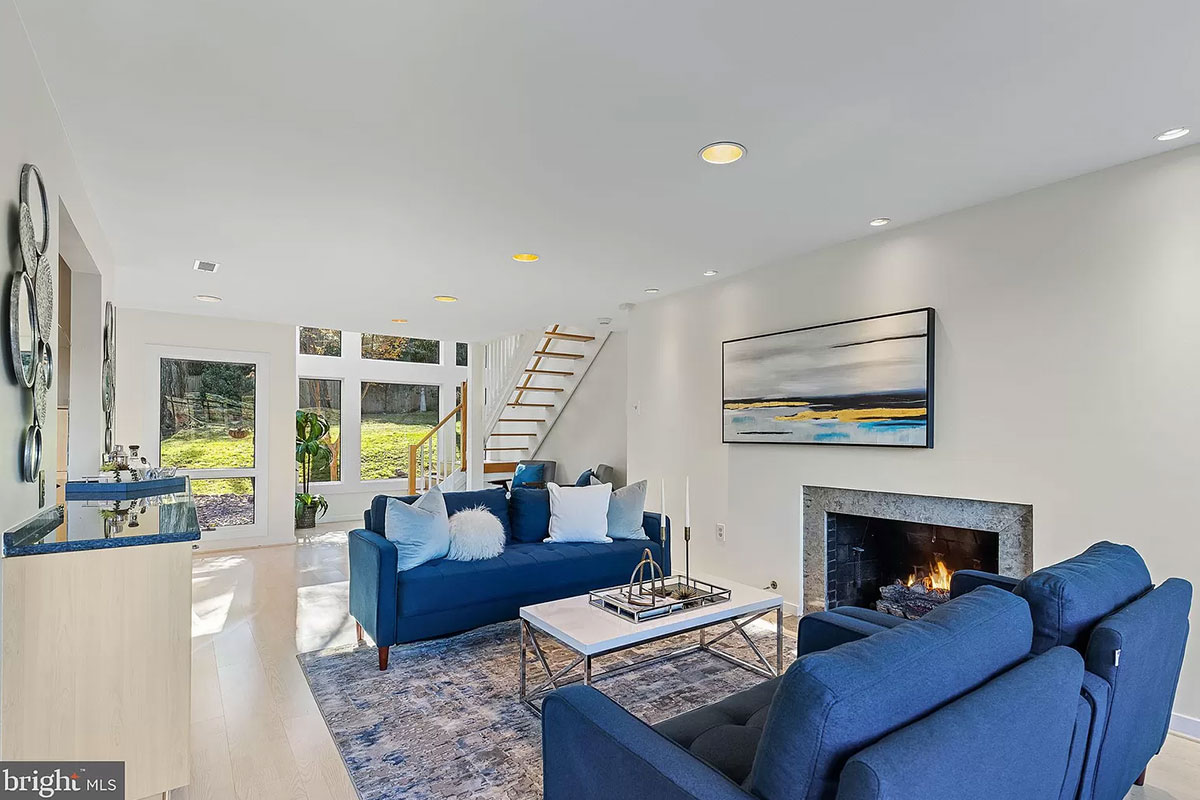 Living room with gas fireplace and windows on one side