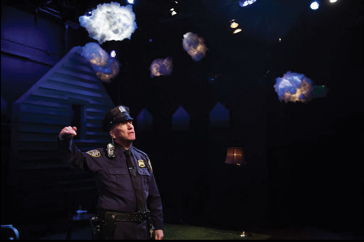 Rauscher on stage dressed as police officer