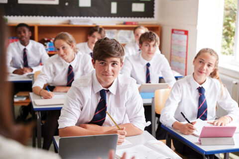 Students in classroom in private school uniforms