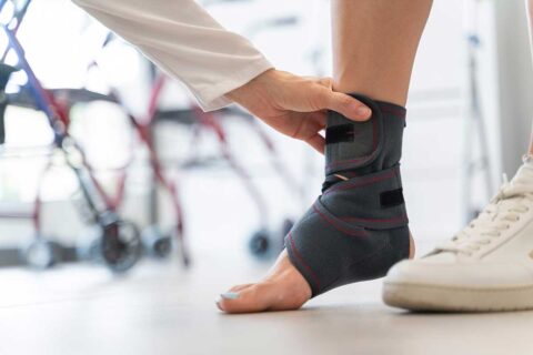 woman wearing ankle brace at doctors office