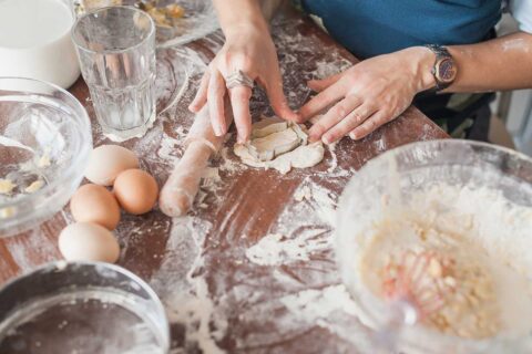 woman making cookies with cookie cutter