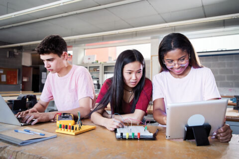 Robotics club students working on computers