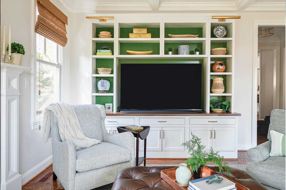 living room with built-in shelves with green backing