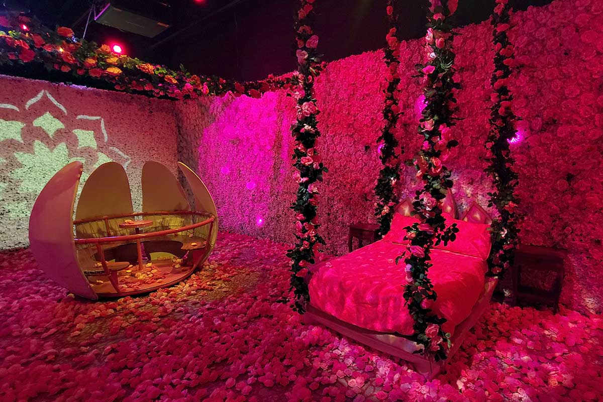 encanto x camp isabella room with flower walls and bed