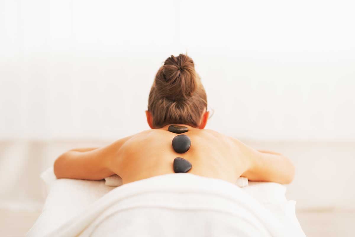 woman getting hot stone massage