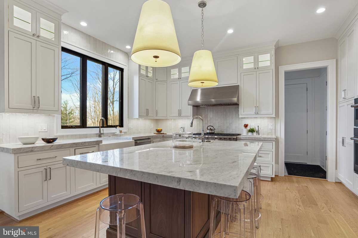 white kitchen with island and stainless steel appliances