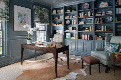 Home office with blue built-in bookshelves