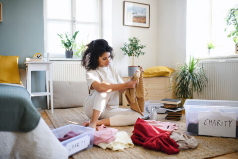 Woman organizing clothes for donation