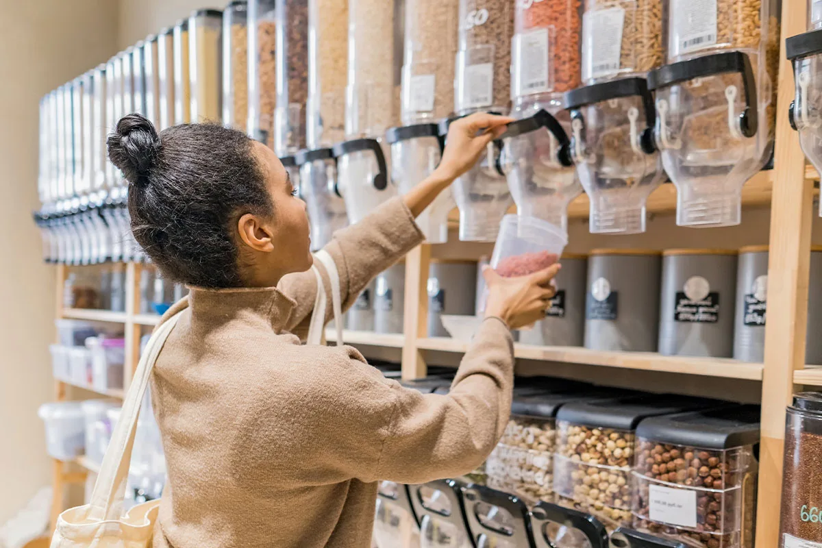 Woman filling jar at zero-waste store
