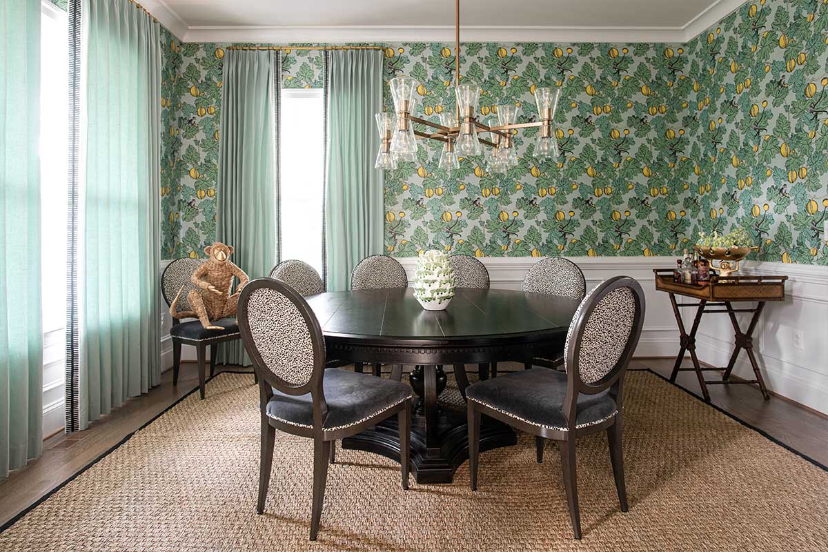 green patterened wallpapered dining room with leopard patterened chairs
