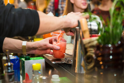 Bartender making cocktail to-go