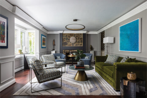 Living room with green couch, stone fireplace