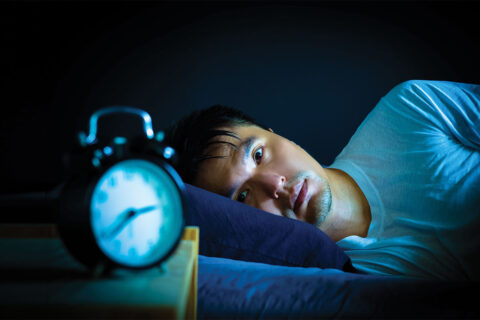 Man lying awake in bed