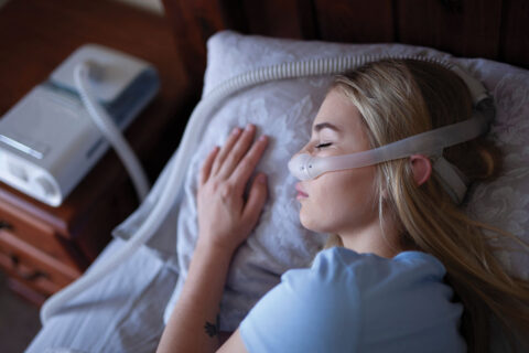Woman sleeping with CPAP machine