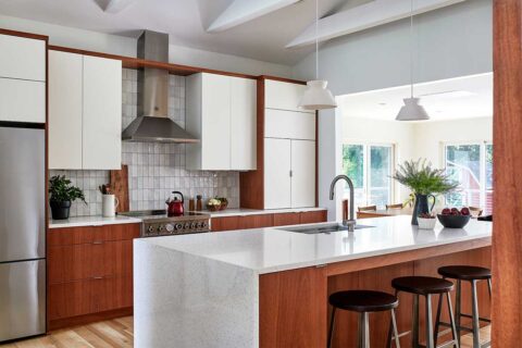 remodeled kitchen with two-toned white and wood cabinets