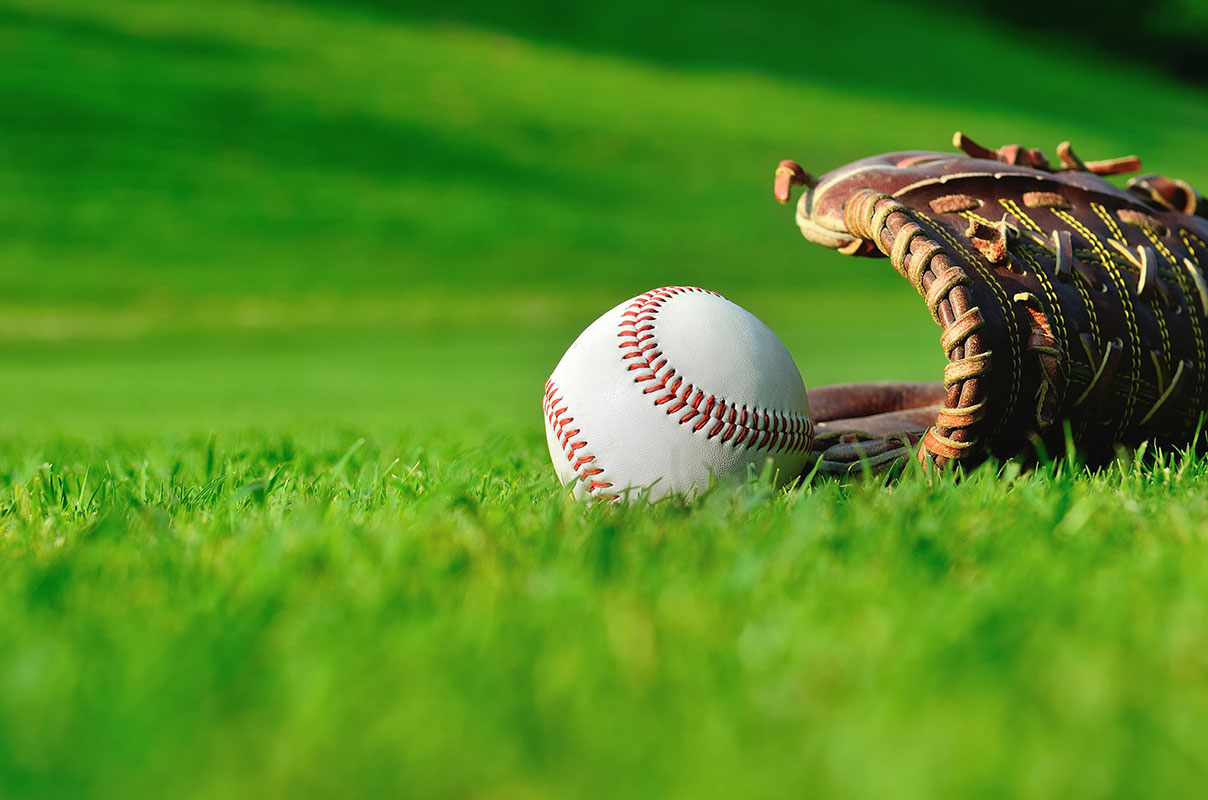 baseball and glove on field
