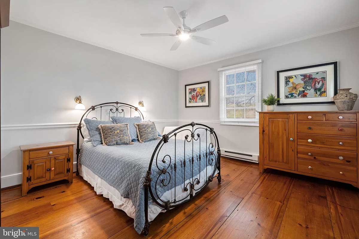 grey bedroom with wide plank floors