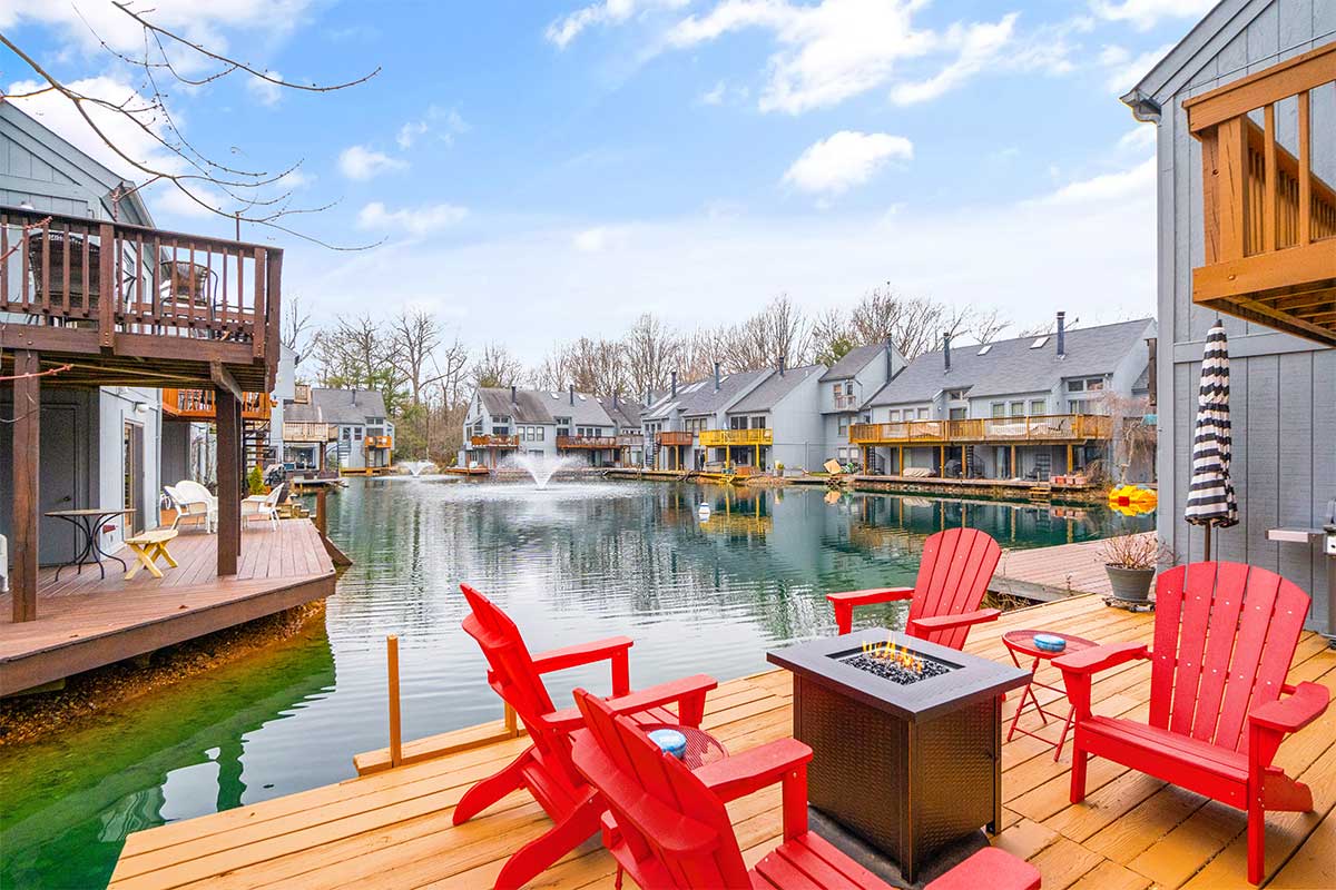 deck with red chairs on a pond