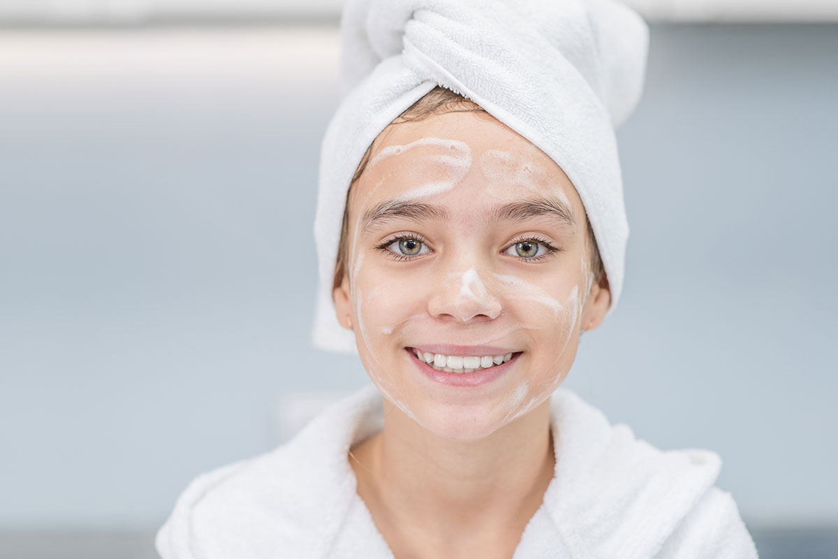 tween with skin care cream on her face