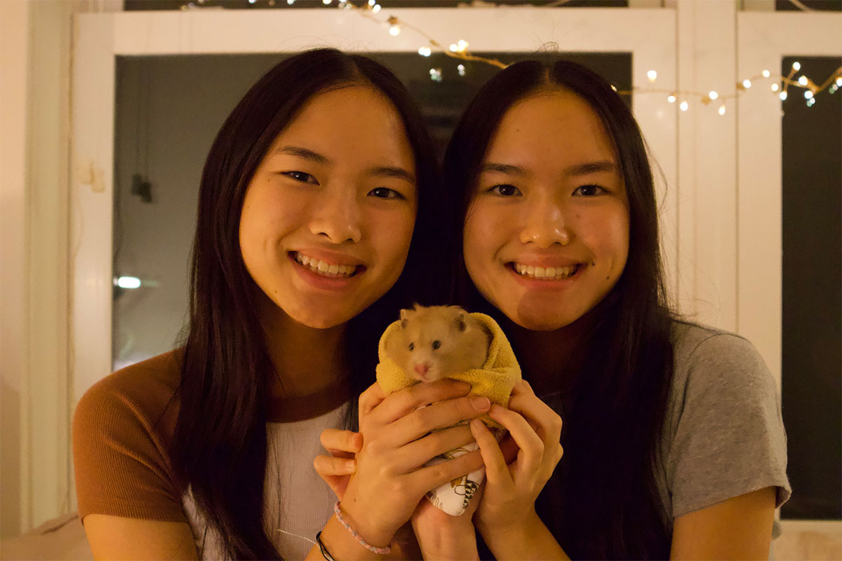 Girls holding hamster