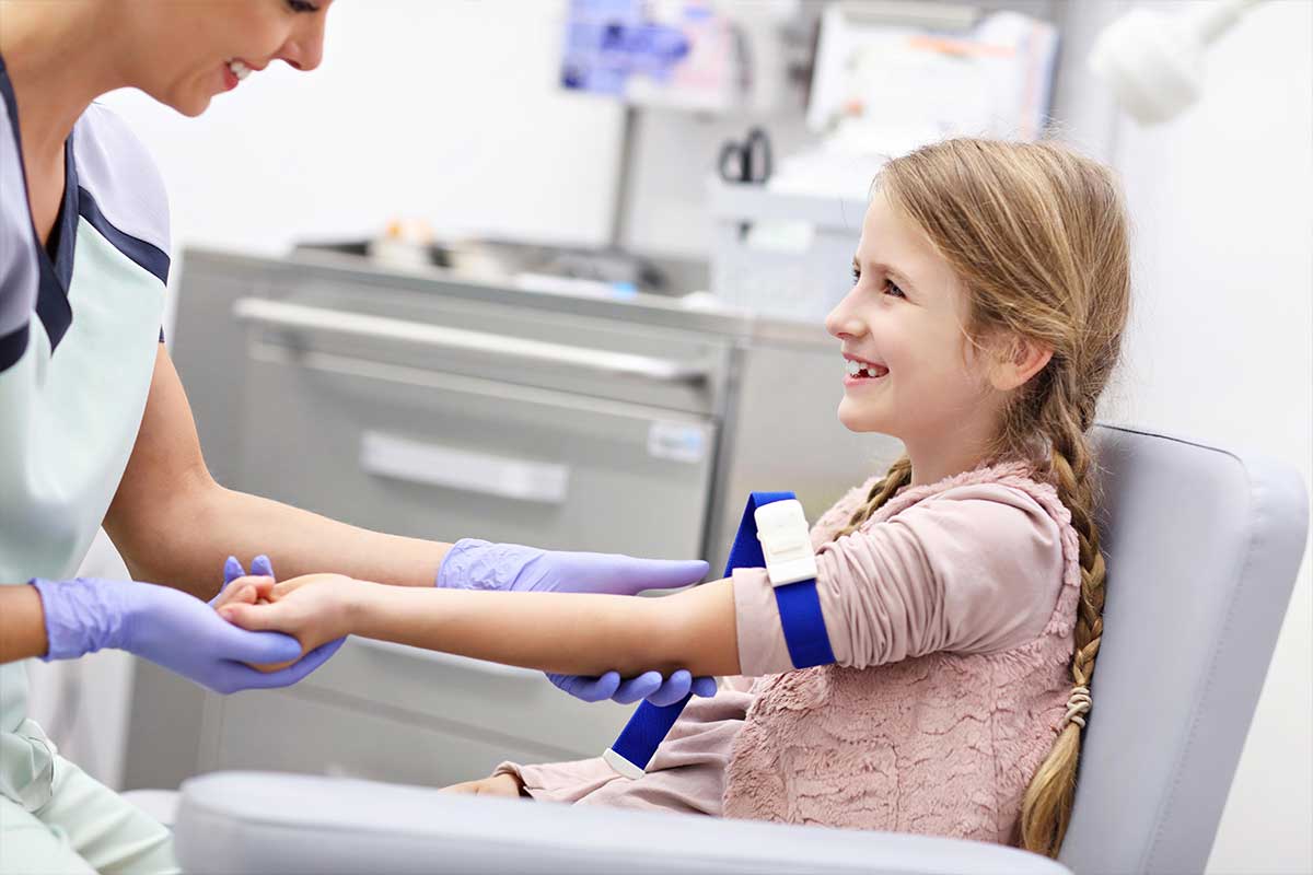 child prepping for blood draw