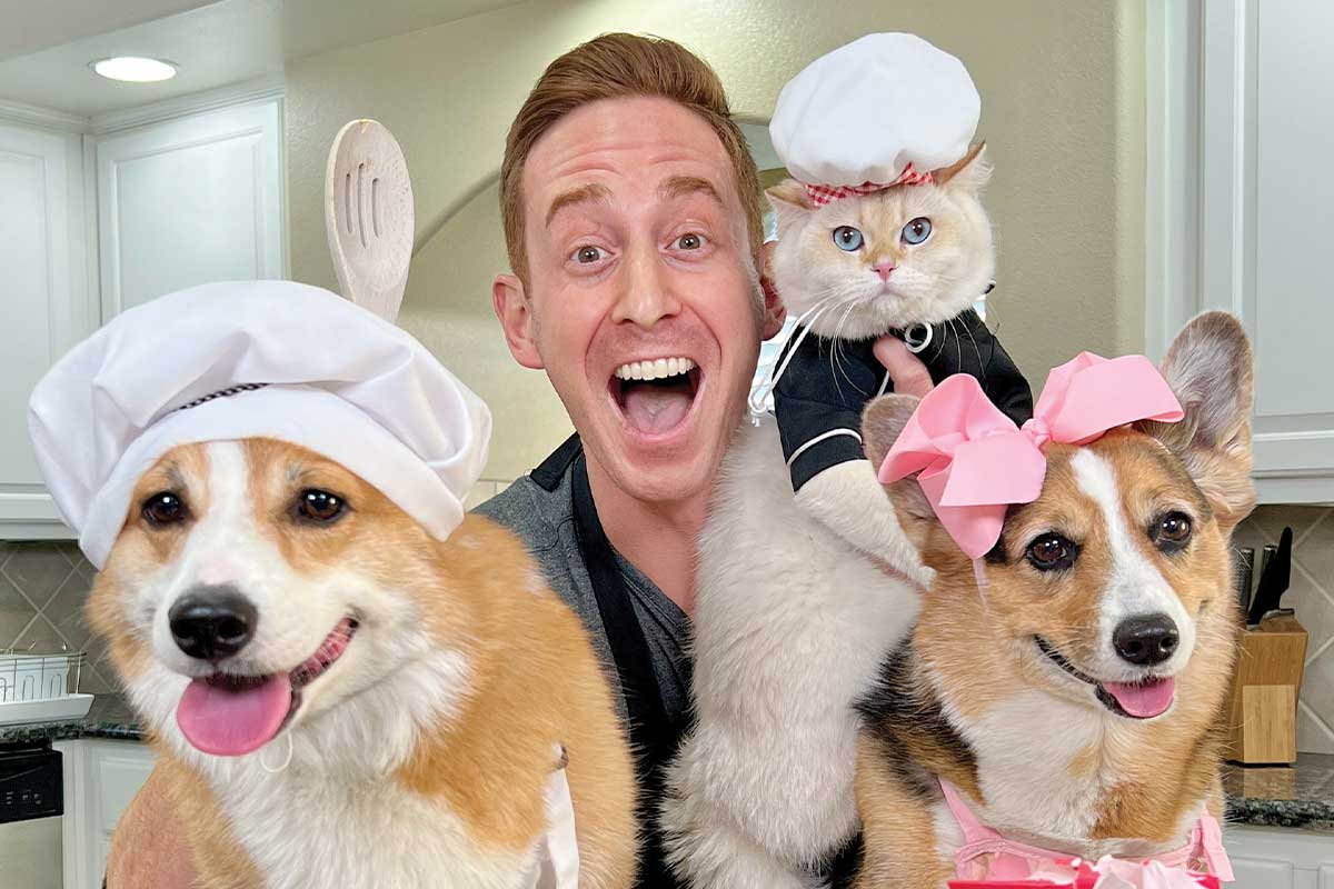 Chris Esquale with two corgis and cat