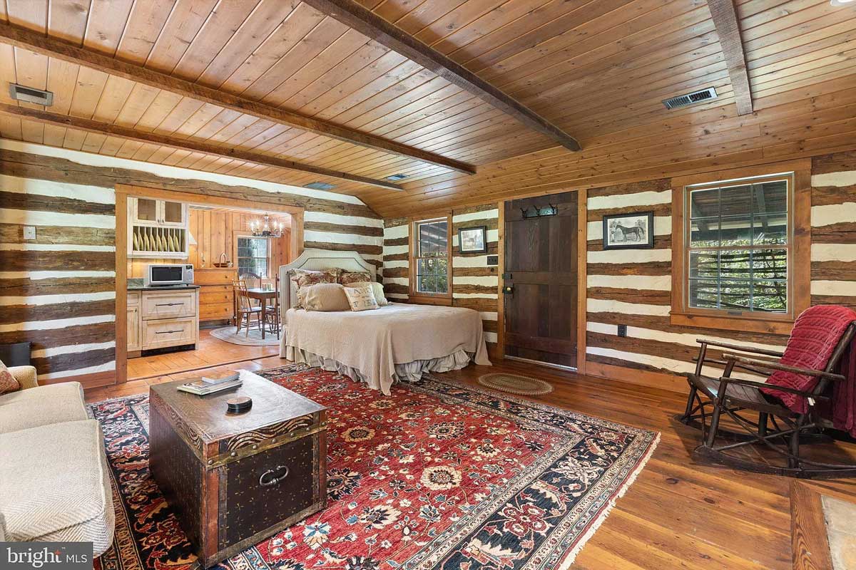 bedroom in cabin with wood ceiling and floor