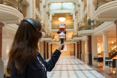 woman looking through augmented reality device