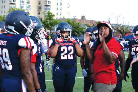 Tiffany Matthews talking to football players