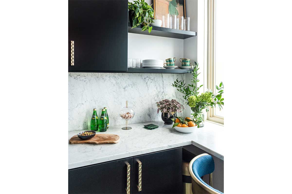 black cabinets with patterned counter and backsplash