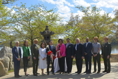 Prime Minister of Japan holds cherry tree that's been donated