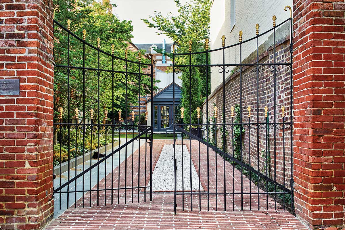 brick driveway with iron gate