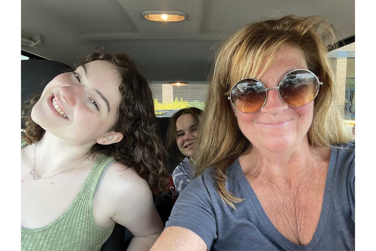 mom with two daughters in car