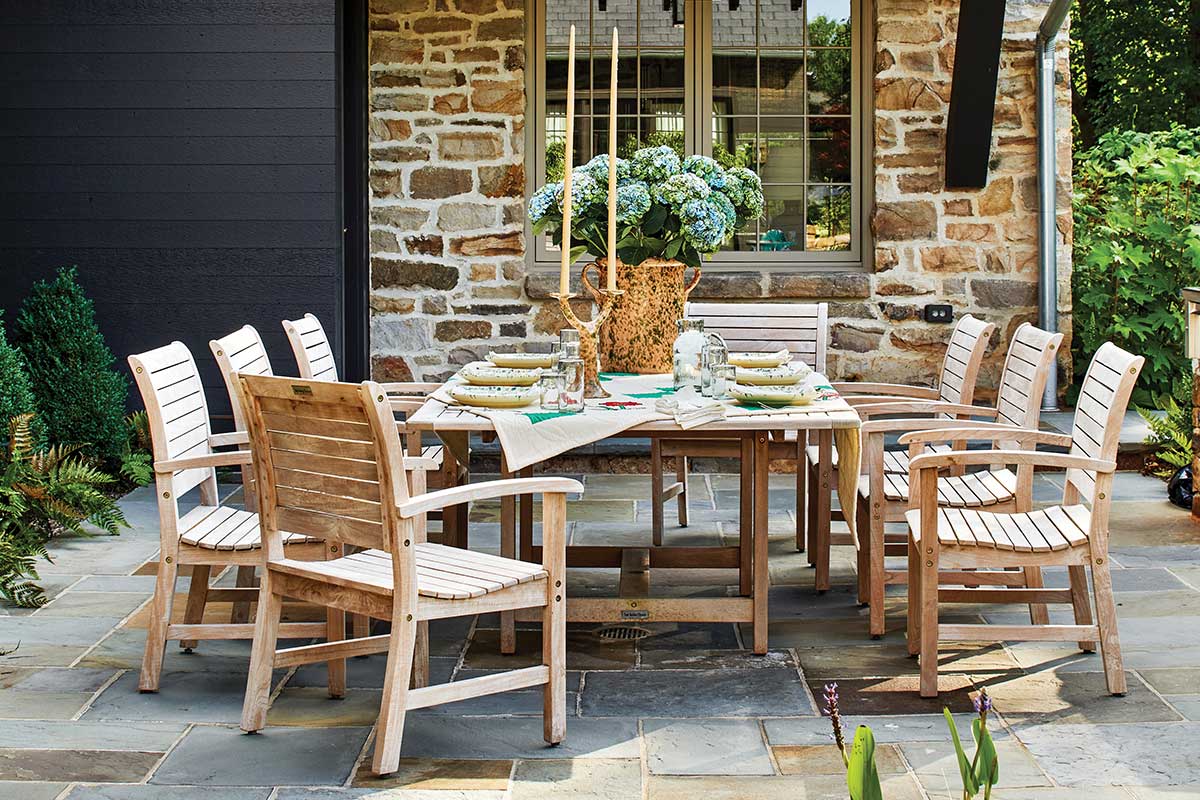 stone patio with wood table and chairs