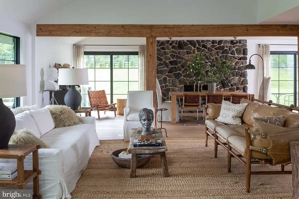 living room with warm accents and wood beam