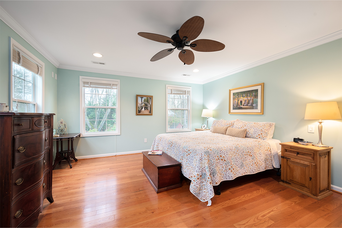 primary bedroom with wood floors