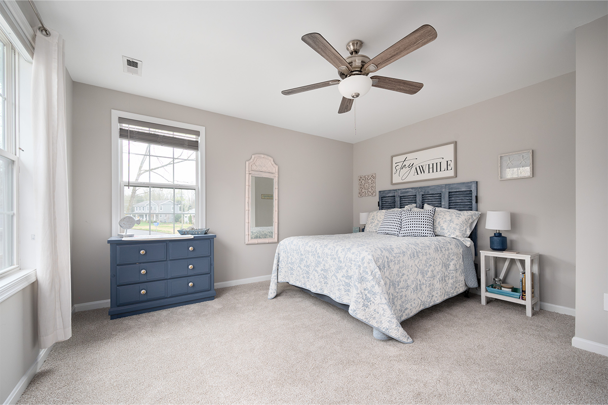 grey bedroom with ceiling fan