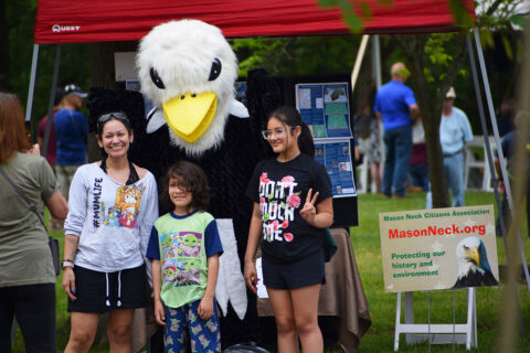 Kids doing photo shoot with eagle mascot