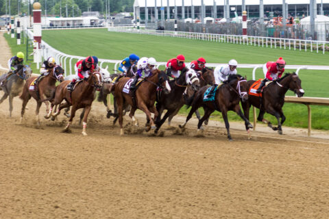 Horses run along the track at the Kentucky Derby