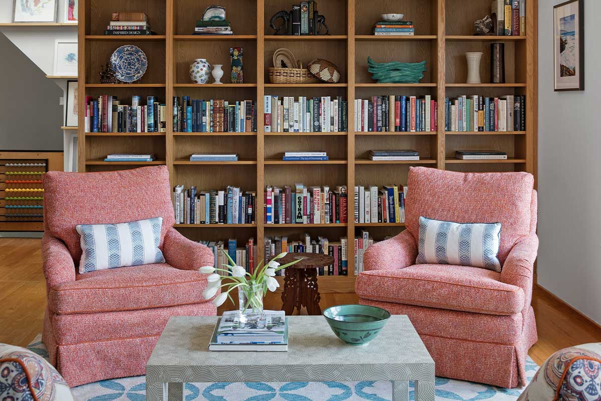 orange chairs in front of bookcase