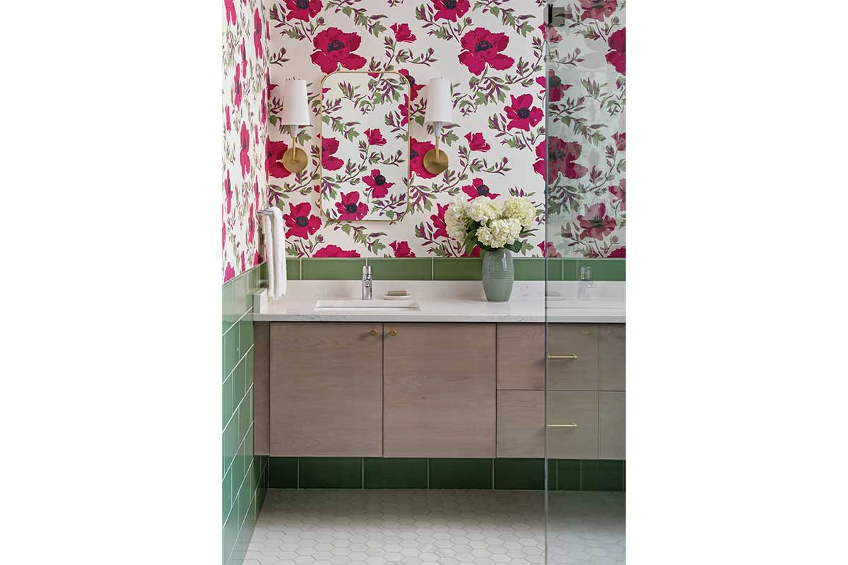 bathroom with green tiles and hot pink floral wallpaper