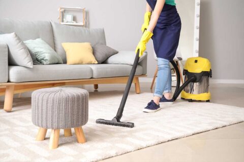 person vacuuming carpet