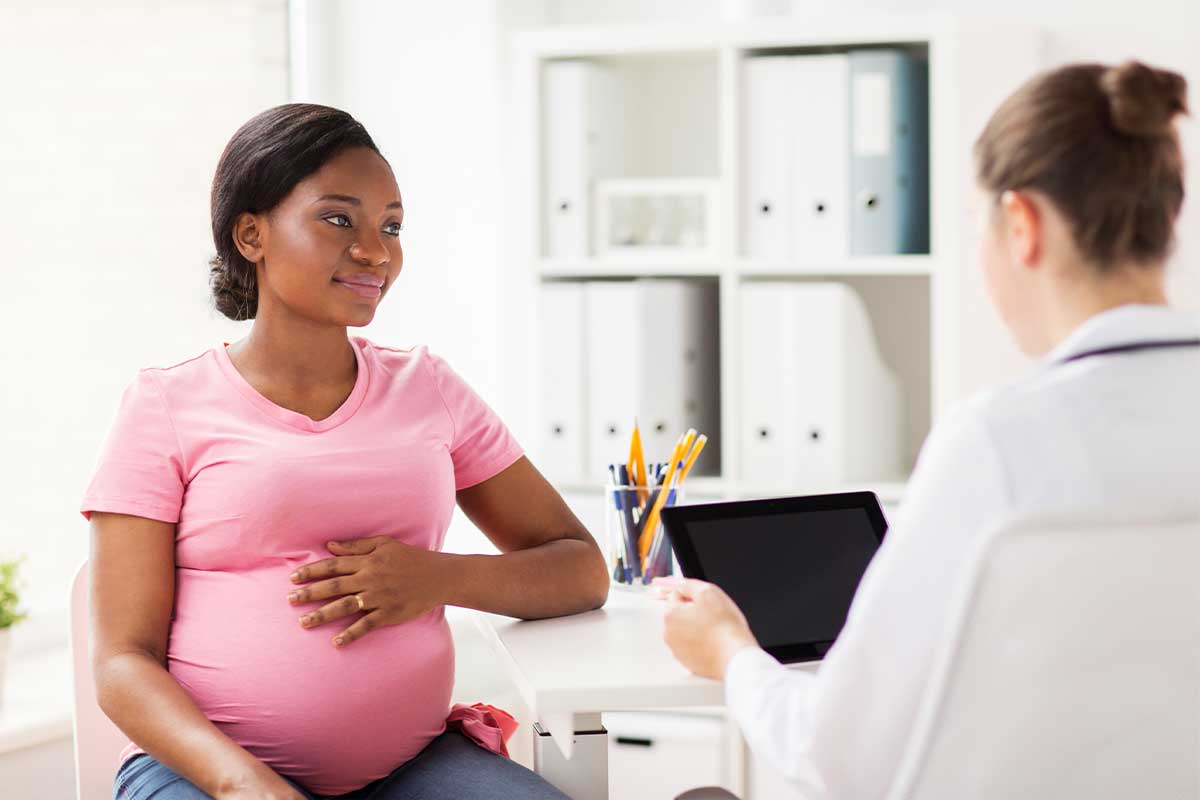 pregnant mom talking to doctor