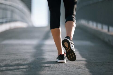 woman walking over bridge