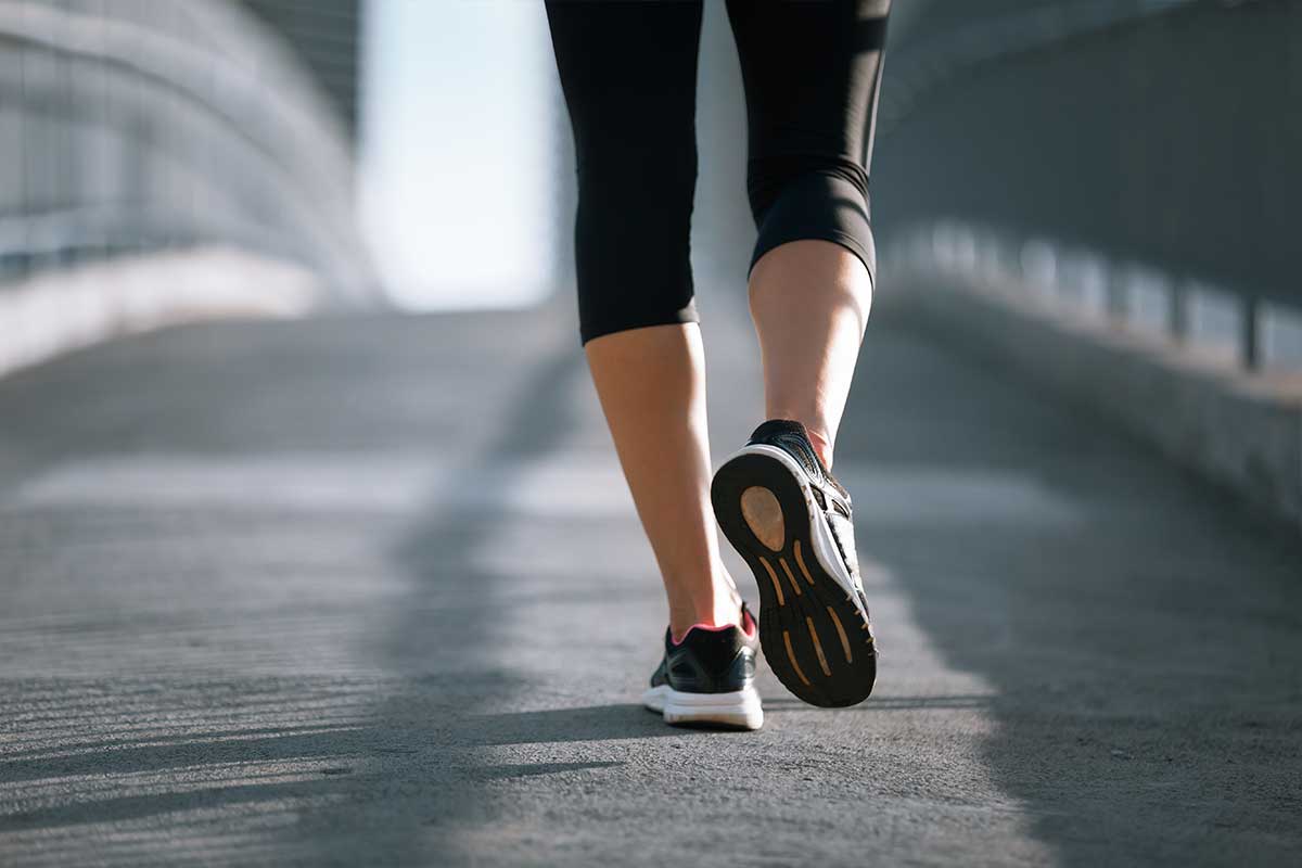 woman walking over bridge