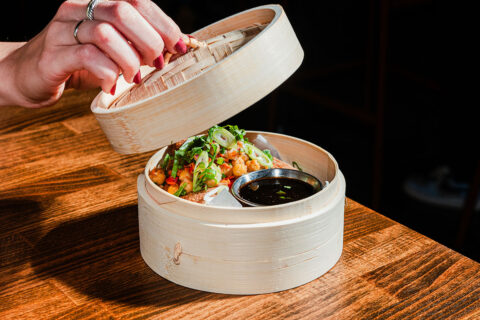 Dish in steamer basket at Immigrant Food