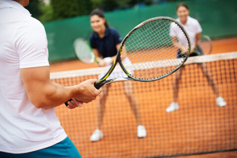 People taking tennis lessons